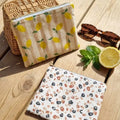 trousses plates en coton enduit motif citron et léopard avec fermeture zippée et format nomade