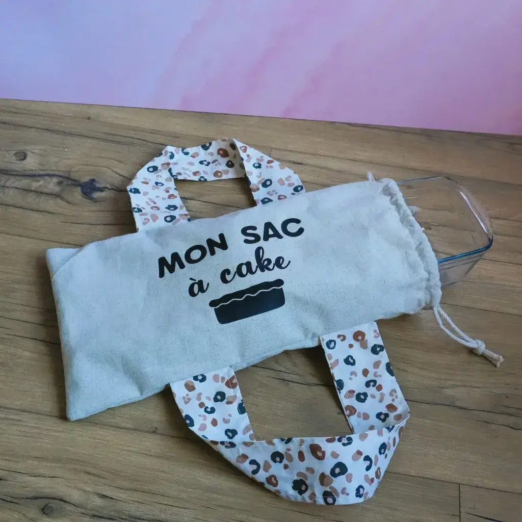 Sac à cake en lin avec anses imprimées pour plat rectangulaire.