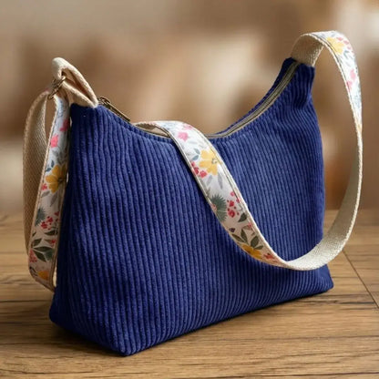 Sac bandoulière bleu roi en velours côtelé avec bandoulière à motifs fleurs.