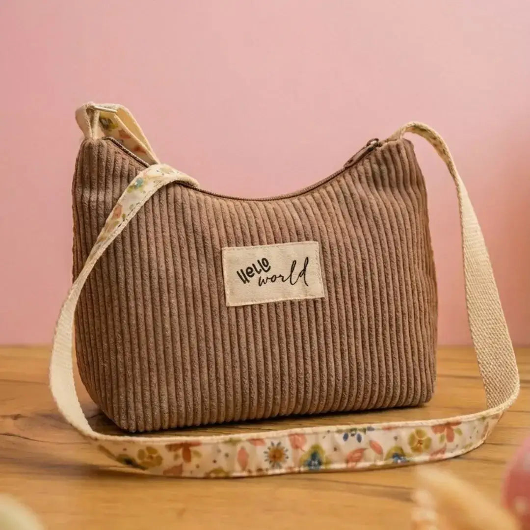 Petit sac bandoulière velours côtelé taupe et sangle motif floral, étiquette Hello World.