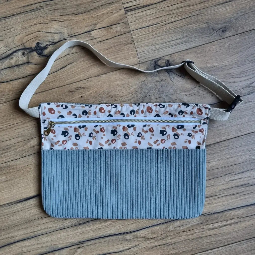 Tablier ceinture en velours côtelé bleu gris à haut léopard, poche zippée et sangle écrue réglable