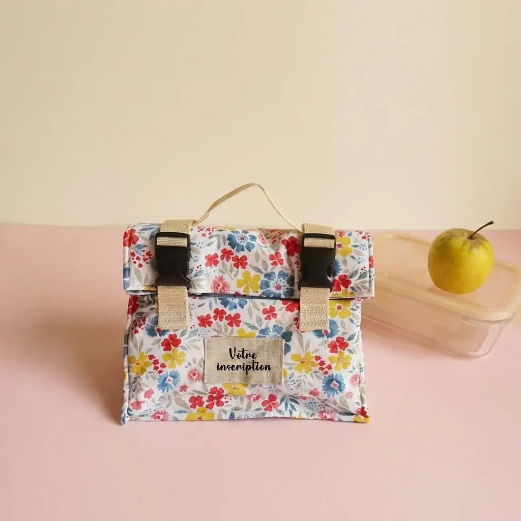 Sac repas fleuri jaune, bleu et rouge avec étiquette à personnaliser et rabat à clips