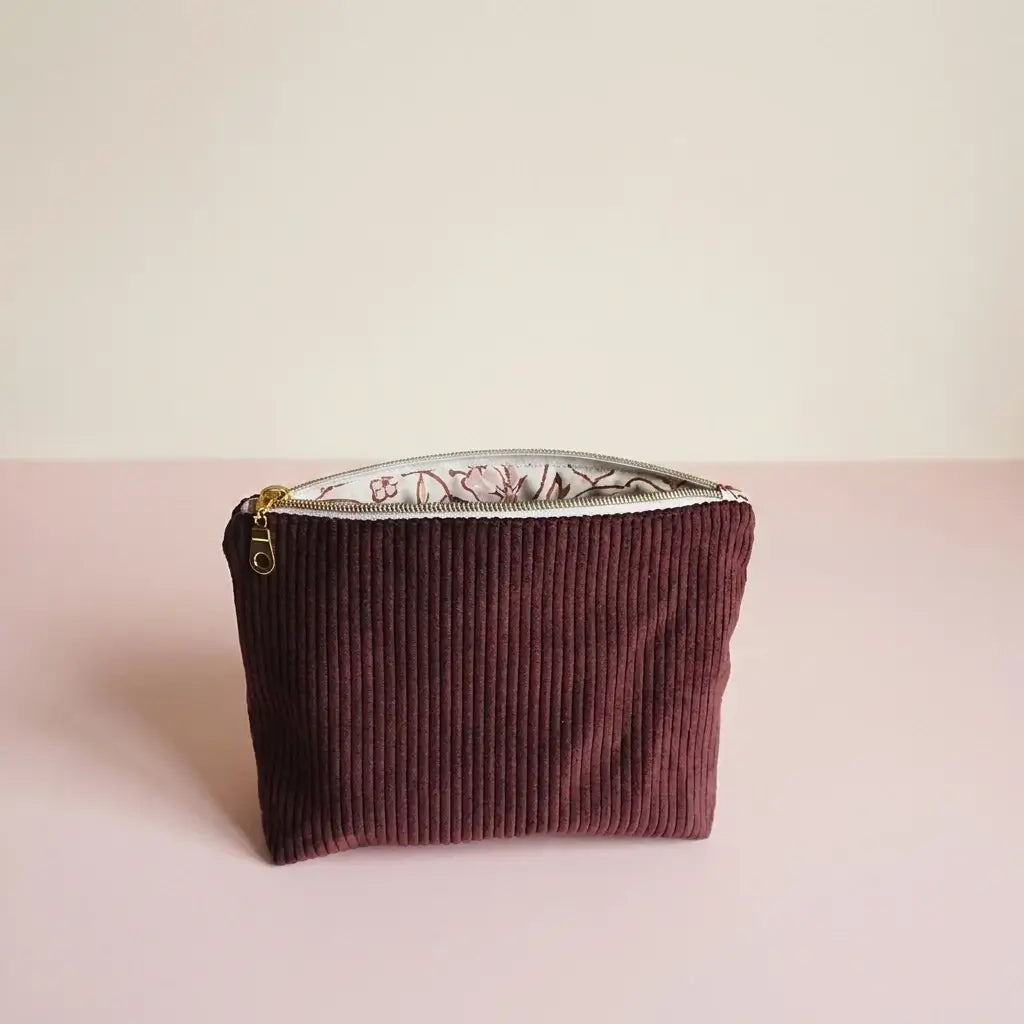 Trousse zippée prune en velours côtelé, doublure claire à fleurs roses et zip doré